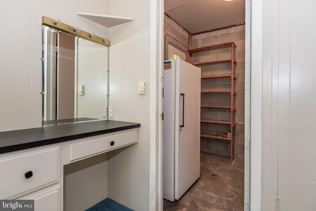 bathroom featuring vanity, wooden walls, and concrete flooring