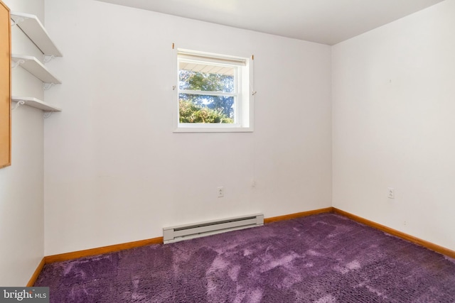 carpeted spare room featuring a baseboard heating unit