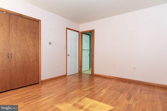 unfurnished bedroom with a closet and light hardwood / wood-style floors