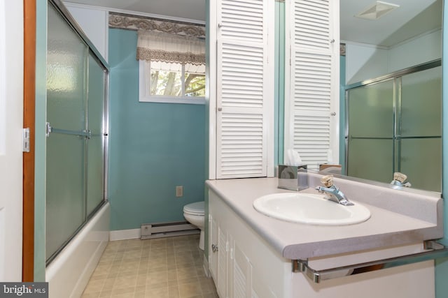 full bathroom featuring baseboard heating, vanity, shower / bath combination with glass door, and toilet