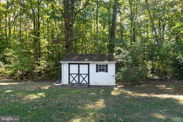 view of outdoor structure featuring a lawn