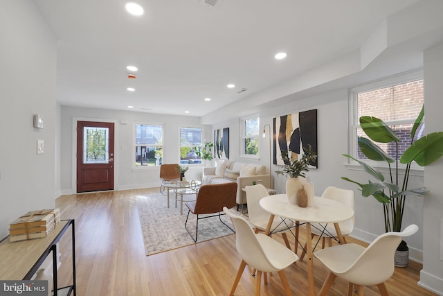 dining space with light hardwood / wood-style floors