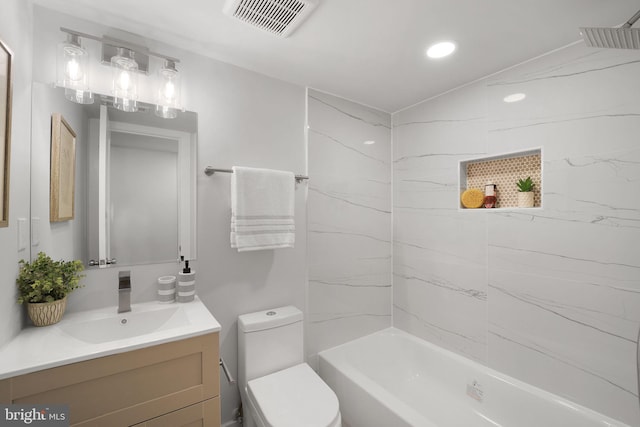 full bathroom featuring vanity, toilet, and tiled shower / bath combo