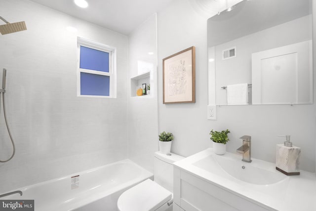 full bathroom featuring vanity, toilet, and tiled shower / bath