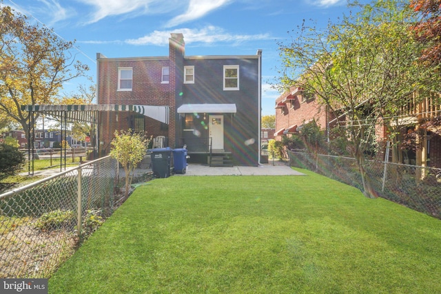 back of house featuring a lawn