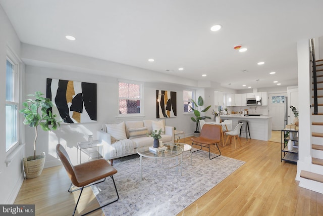 living room with plenty of natural light and light wood-type flooring