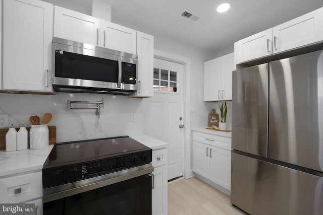 kitchen featuring white cabinetry and stainless steel appliances