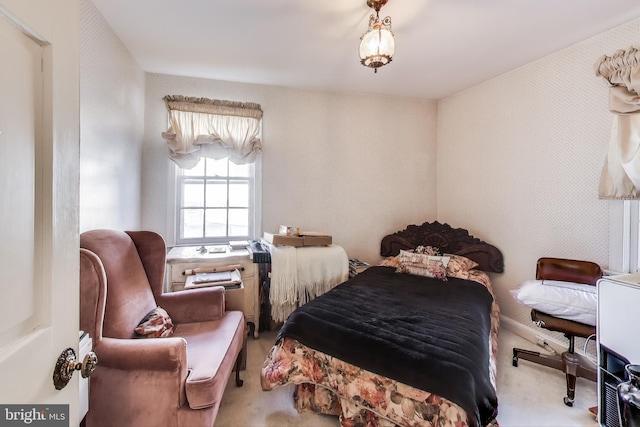 bedroom featuring wallpapered walls and carpet