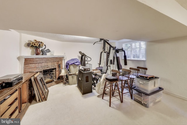 workout room featuring carpet floors and a brick fireplace