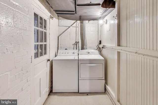 clothes washing area featuring washer and dryer and laundry area