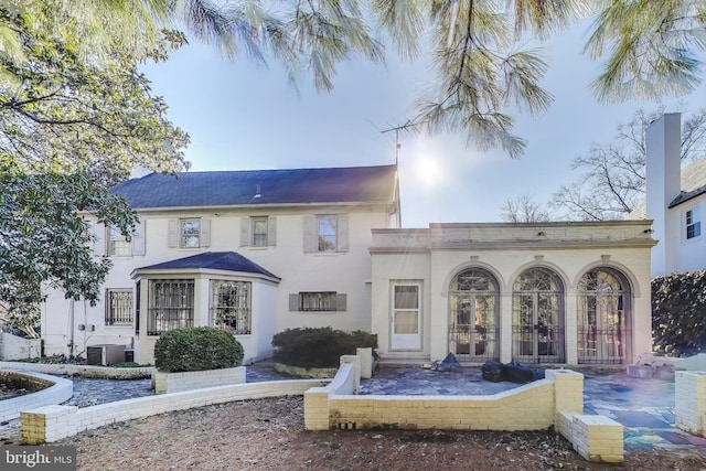 rear view of property with cooling unit