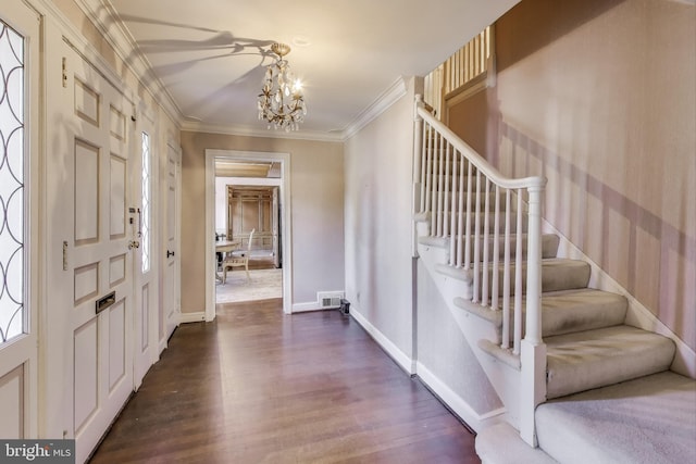 entryway with dark wood-style floors, baseboards, an inviting chandelier, ornamental molding, and stairs