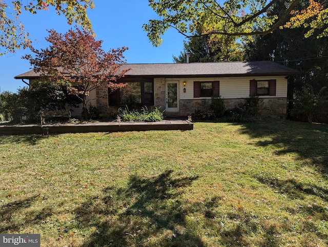 ranch-style home with stone siding and a front lawn