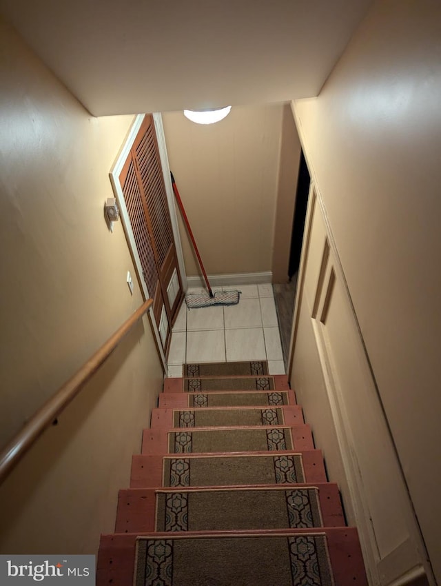 stairway featuring tile patterned floors
