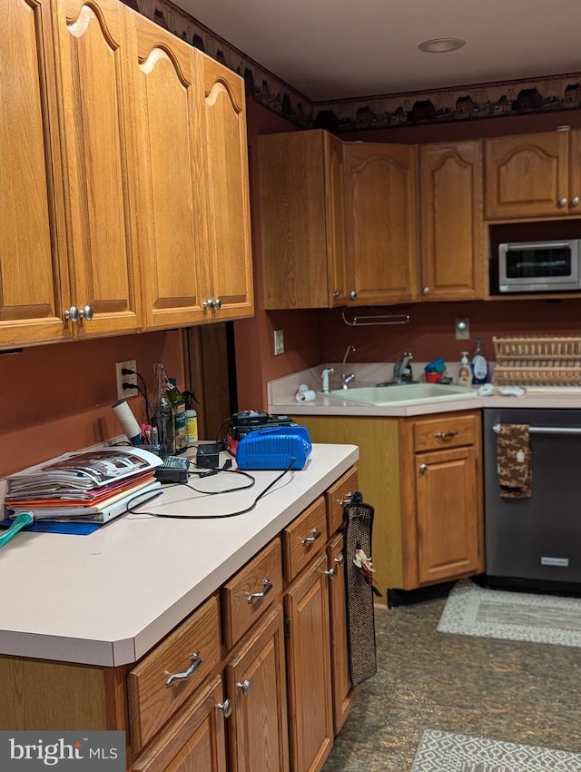 kitchen featuring a sink, brown cabinetry, light countertops, and black dishwasher