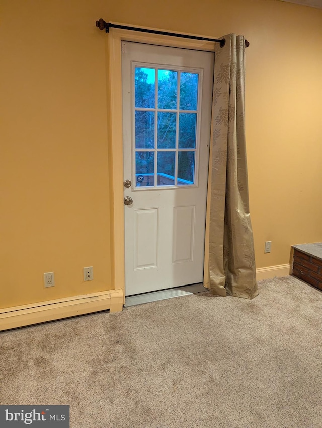 entryway featuring baseboard heating, baseboards, and carpet floors