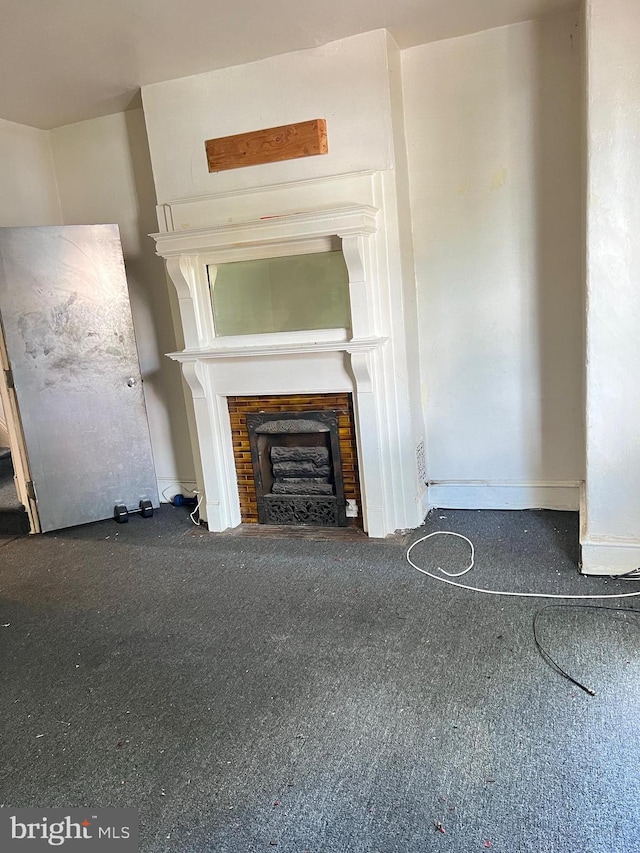 unfurnished living room with dark colored carpet