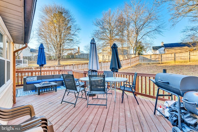 wooden deck with a grill and an outdoor living space with a fire pit