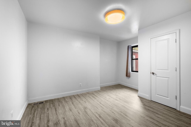 spare room featuring light wood-type flooring