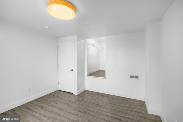 empty room featuring dark wood-type flooring