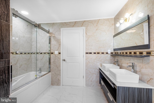 bathroom with enclosed tub / shower combo, vanity, tile walls, and ornamental molding