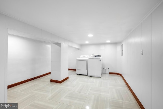 clothes washing area with electric panel, washer and dryer, and crown molding