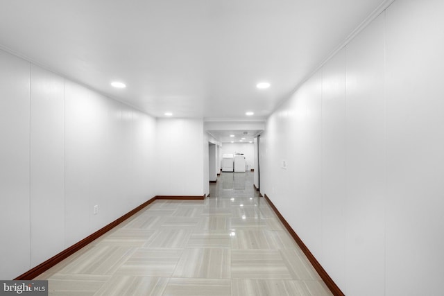 hall featuring crown molding and light tile patterned floors