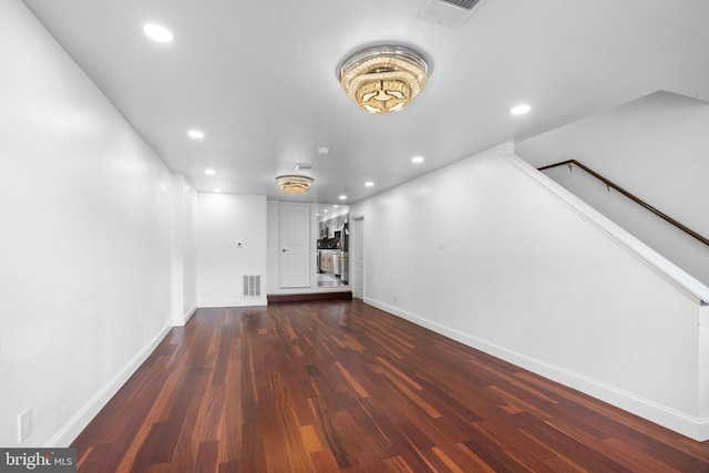 unfurnished living room featuring dark hardwood / wood-style floors