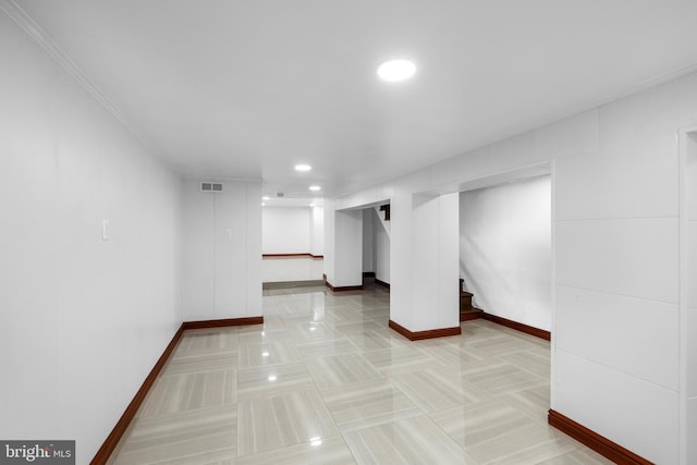 interior space with ornamental molding and tile patterned floors