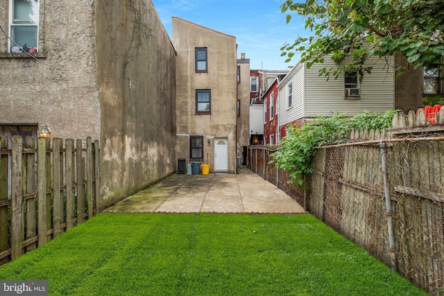 back of property with cooling unit, a yard, and a patio