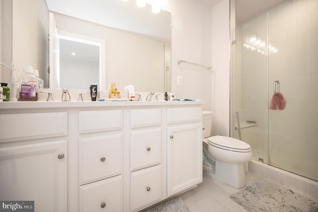 bathroom featuring vanity, toilet, tile patterned floors, and a shower with door