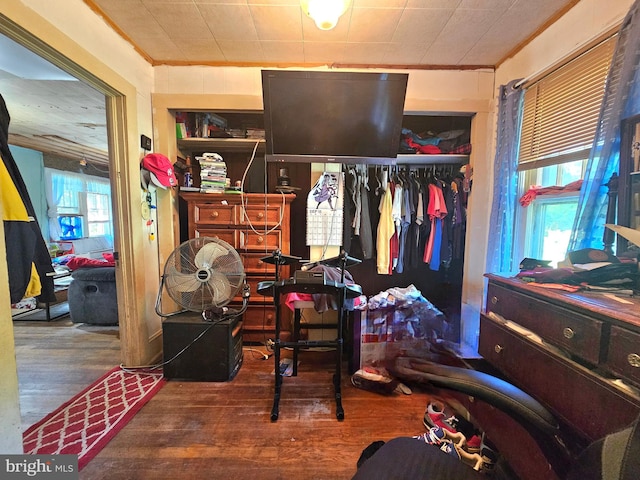 bedroom featuring a closet, ornamental molding, and hardwood / wood-style floors