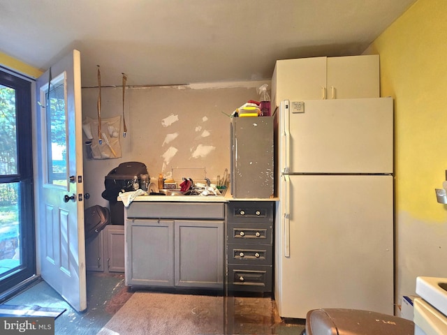 kitchen featuring gray cabinetry and white refrigerator