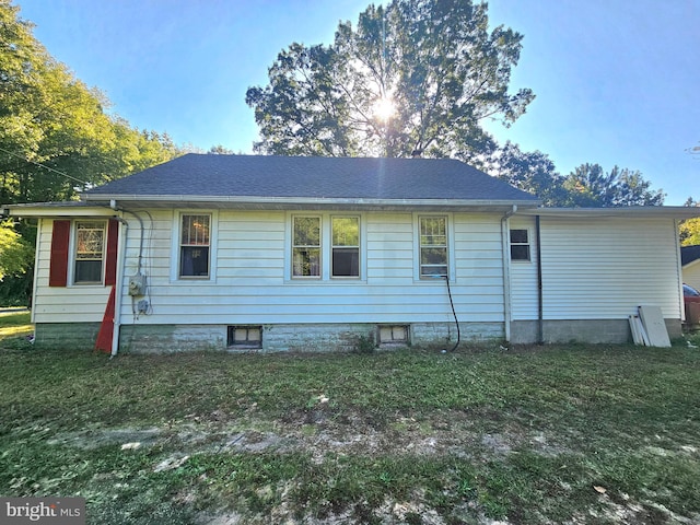 rear view of house with a yard