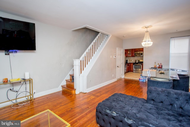 living room with a notable chandelier and dark hardwood / wood-style floors