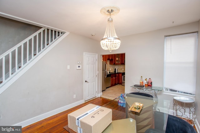 interior space featuring an inviting chandelier and hardwood / wood-style floors