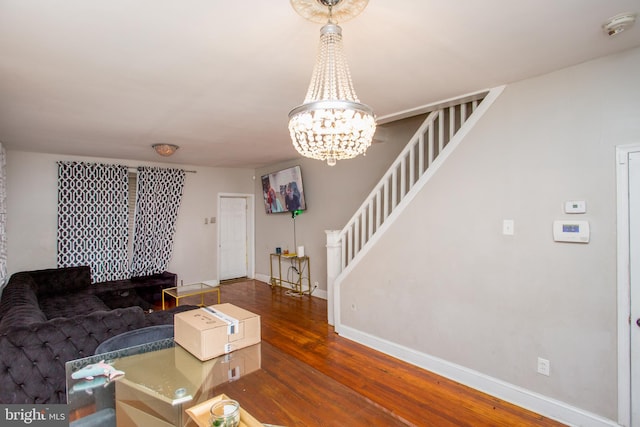 living room with a chandelier and dark wood-type flooring