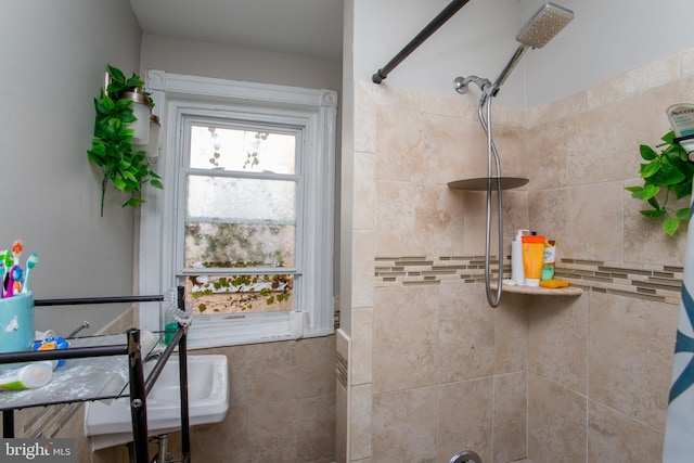 bathroom with tile walls and tiled shower