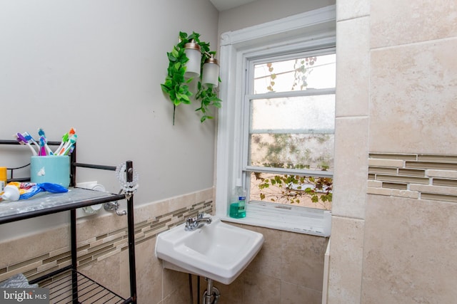 bathroom with tile walls and sink