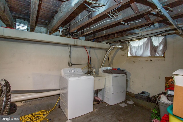 basement with sink and washer and dryer