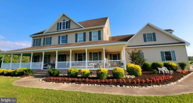 view of front of home featuring covered porch and a front yard