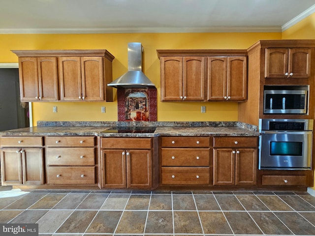 kitchen featuring appliances with stainless steel finishes, ornamental molding, and wall chimney range hood