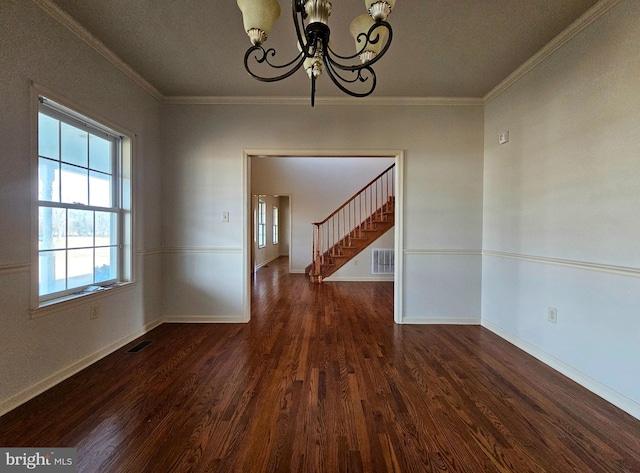 unfurnished dining area featuring dark hardwood / wood-style floors, an inviting chandelier, and crown molding