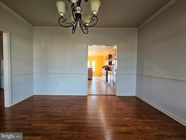 unfurnished room featuring a chandelier, dark hardwood / wood-style floors, and crown molding