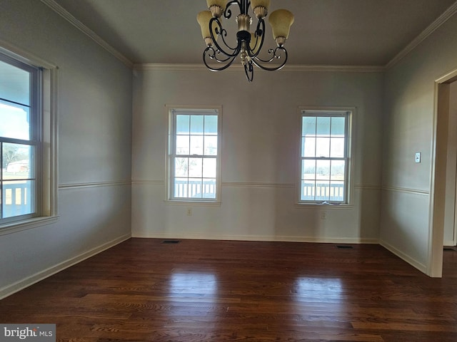 unfurnished room with a healthy amount of sunlight, dark hardwood / wood-style floors, and a notable chandelier