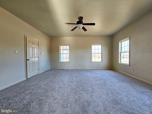 carpeted spare room with ceiling fan and a healthy amount of sunlight