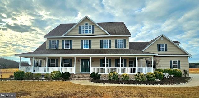 view of front of house with a porch and a front yard