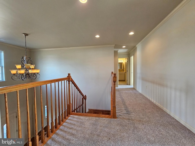 stairs with carpet, ornamental molding, and a chandelier