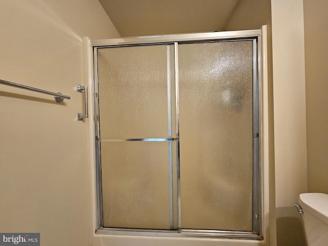 bathroom with an enclosed shower and toilet