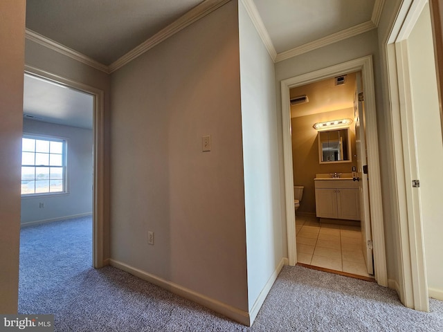 hallway featuring light colored carpet and ornamental molding